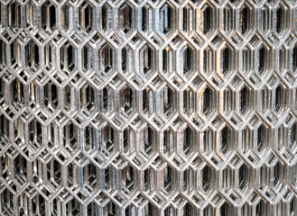 close up of a roll of steel mesh in a hexagon pattern, silver color, layers of mesh.