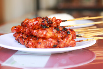 Satay (Indonesian: Sate) is a Indonesian dish of seasoned, skewered and grilled meat, served with a sauce. 