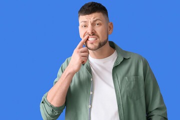 Man suffering from tooth ache on color background