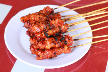 Satay (Indonesian: Sate) is a Indonesian dish of seasoned, skewered and grilled meat, served with a sauce. 