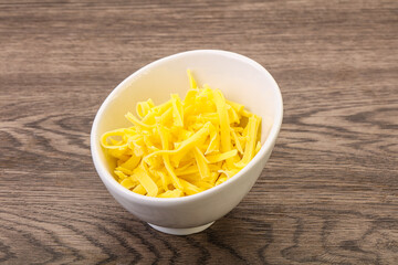 Shredded yellow cheese in the bowl