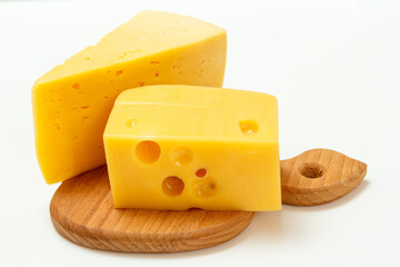Cheese on wooden cutting board on white background