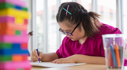 Girl with Down syndrome drawing picture