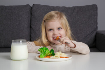 Adorable little girl eating vegetables. Dieting Concept. Healthy eating habbits for kids.