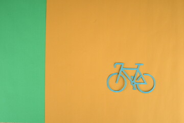 yellow bicycle with space on green and orange background - Powered by Adobe