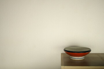 red white ceramic bowl on white wall beautiful background