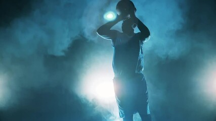 African american player is throwing a basketball in slow motion - Powered by Adobe