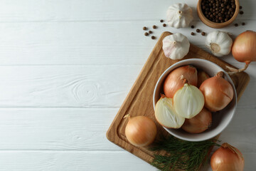 Fototapeta na wymiar Fresh onion, garlic, dill and pepper on white wooden background