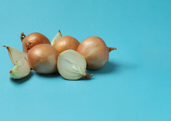 Group of fresh ripe onion on blue background