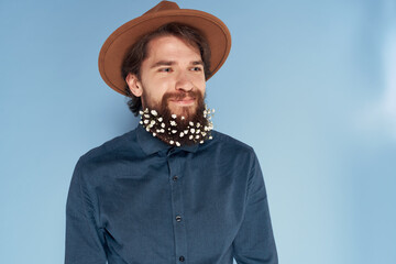 Cheerful man beard with flowers emotions cropped view blue background