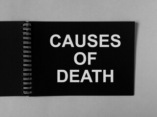 Causes of death on black paper of spiral notebook