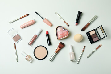 Different makeup cosmetics on white background, top view