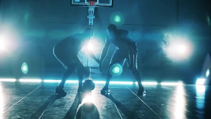 Two african american men are playing basketball in slow motion