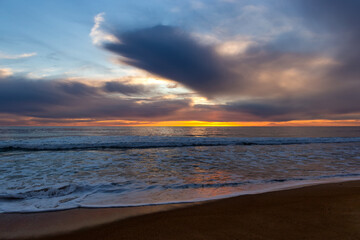 Obraz na płótnie Canvas View of a sunset over a sea.