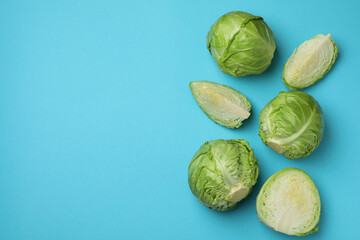 Fresh green cabbage on blue background, space for text
