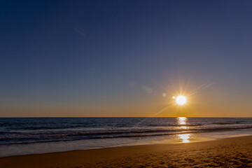 Sunset over sea coast. Summer evening.