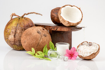 Coconut grater,Shredded coconut,Whole coconut ,half of coconut and oil in the glass bottle isolated on white background.