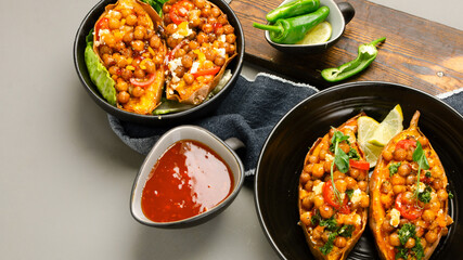 Stuffed sweet potato with spiced chickpea, dressing and herbs.