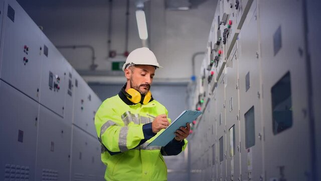 Engineer checking and inspecting at MDB panel , working with electric switchboard to check  medium Voltage Switchgear working in Main Distribution Boards factory.