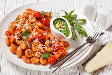Potato gnocchi with tomatoes and pesto, top view