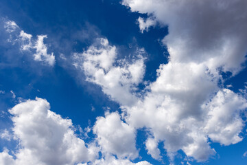 Beautiful blue sky with white cumulus clouds (cumulonimbus), bottom view, full frame, photography.