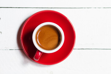 top view of red cup with fresh coffee on saucer on white background, panoramic shot