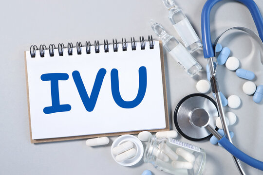 IVU. text on white paper, gray background, near pills and stethoscope in blue