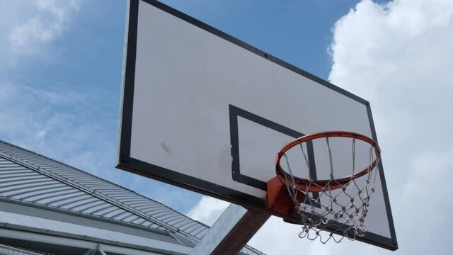 4k Smooth Tilting Footage Looking Up At An Urban Basketball Hoop
