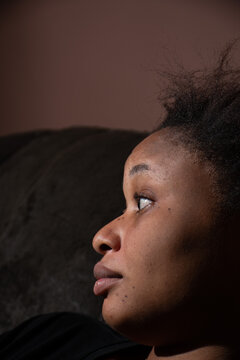 Closeup Side View Portrait Of A Pretty Black Woman With Freckles And Natural Hair