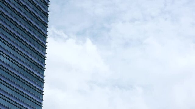 4k Footage Of An Abstracted View Of A Corporate Building, With Passing Clouds And Copy Space.