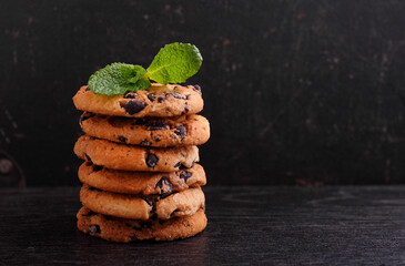 Chocolate chip cookies stack over dark background