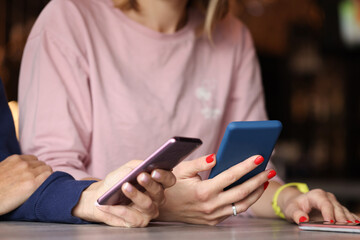 Two people are holding smartphones in their hands closeup