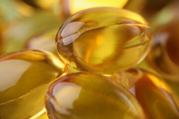 Golden transparent capsules in organic packaging closeup