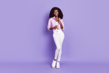 Fototapeta na wymiar Full size photo of young beautiful stunning charming lovely african woman posing isolated on violet color background