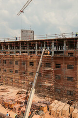 Construction site of multi-storey building with concrete slabs and columns. Men at work .