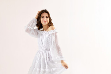 beautiful young brunette woman in white dress