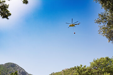 Fototapeta na wymiar Wildfires in Turkey. Kemer. Firefighter helicopter. Mountain ranges