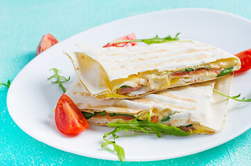 Homemade flatbread with ham, eggs, cheese and tomatoes and green herbs. Traditional  flatbread.