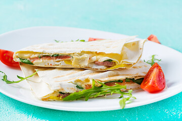 Homemade flatbread with ham, eggs, cheese and tomatoes and green herbs. Traditional  flatbread.