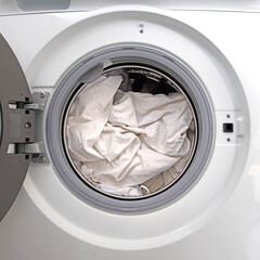 Washing machine filled with white laundry