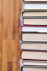 Books are in row on wooden table closeup