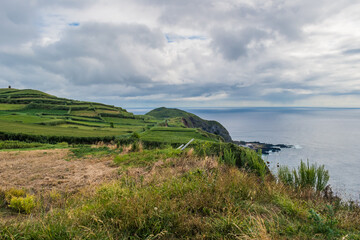 Green fields of cultivation on cliffs next to the Atlantic Ocean in Ponta da Ferraria, São Miguel - Azores PORTUGAL