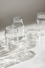 empty jars with shadow on white