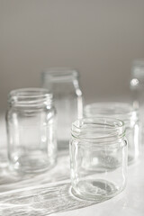 empty jars with shadow on white
