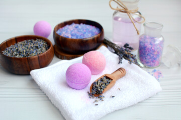 Spa treatments. Sea salt, scented balls, lavender branches, lavender oil on a white towel