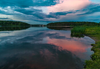 Sunset light in the sky over the lake in the East in summer