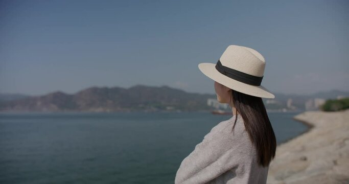 Woman look at the sea beach