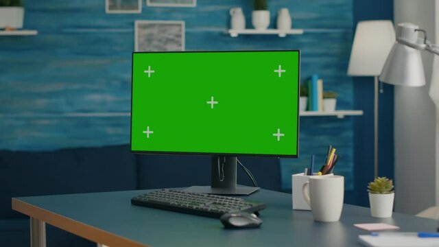 Modern computer with mock up green screen chroma key set up for personal business work. Professional pc with isolated display sitting on office desk in home office with nobody in it