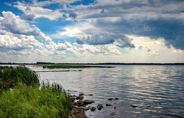 The sky with thunderclouds on the pond in summer