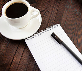 coffee and notepad on wooden background